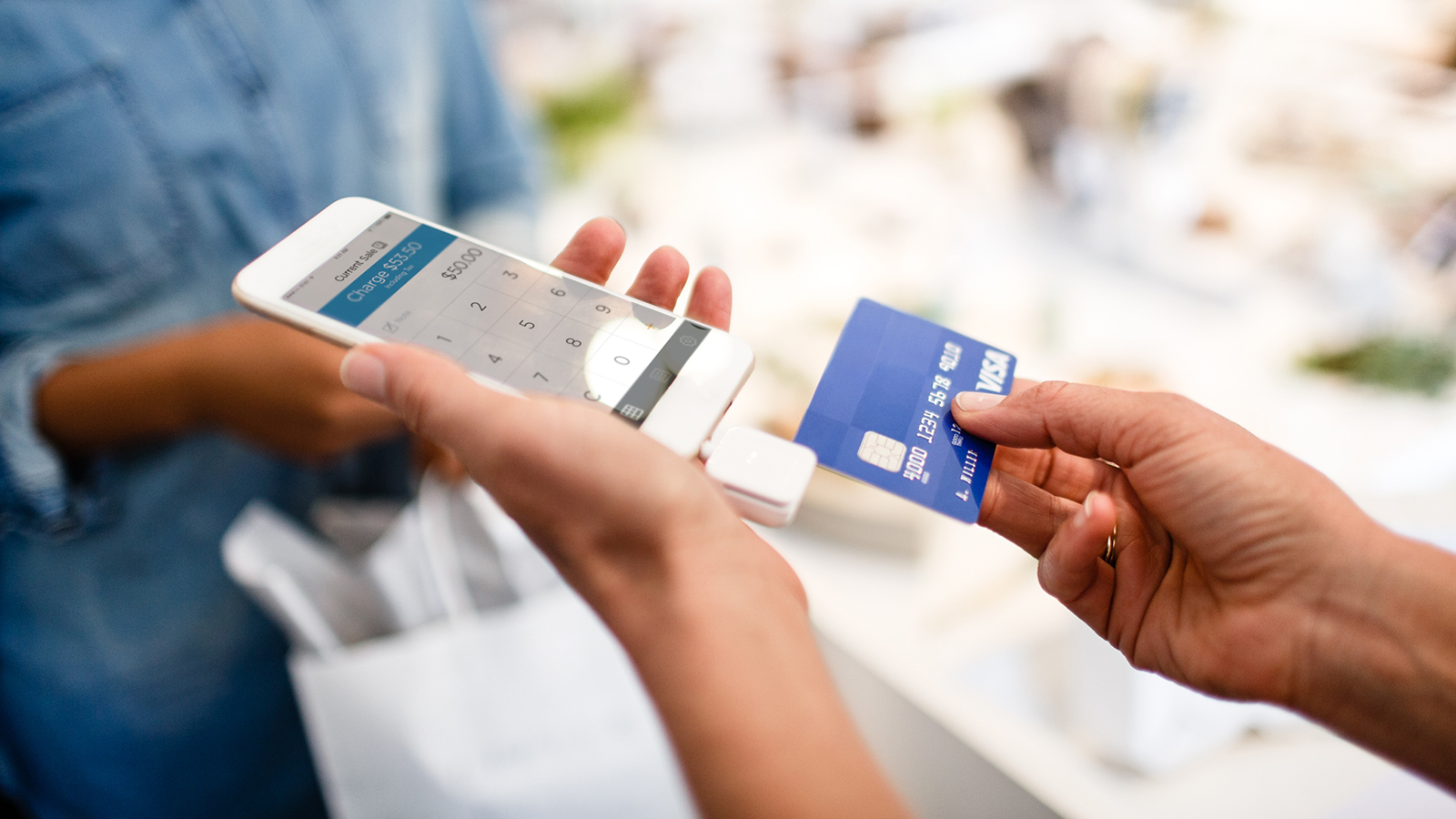 Merchant using a mobile phone to complete a transaction 