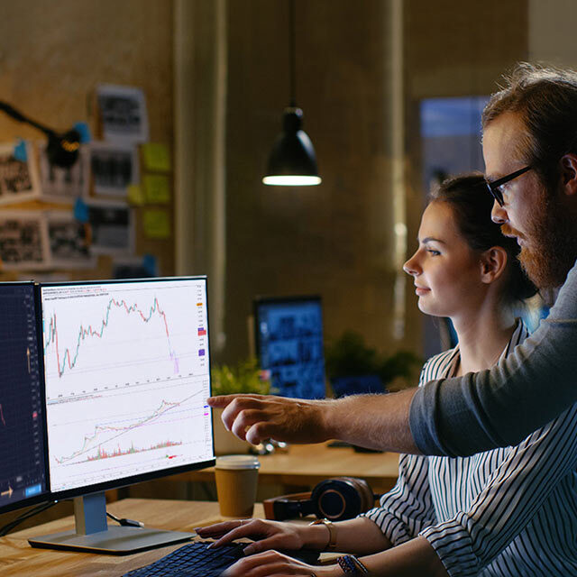 man and woman looking at crypto